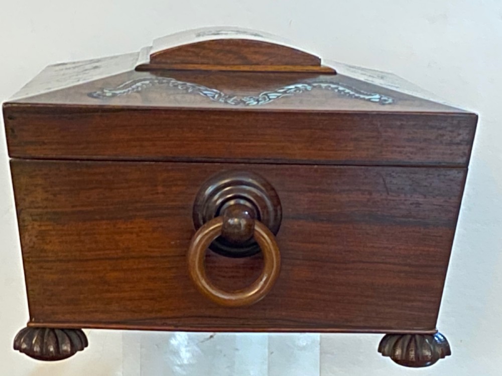 A Regency rosewood workbox with mother-of-pearl foliate inlays, side ring handles, and carved feet. View III