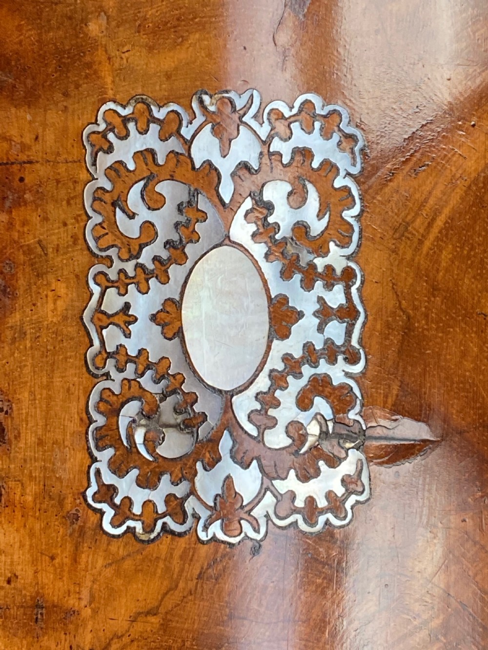 A Regency rosewood workbox with mother-of-pearl foliate inlays, side ring handles, and carved feet. View V