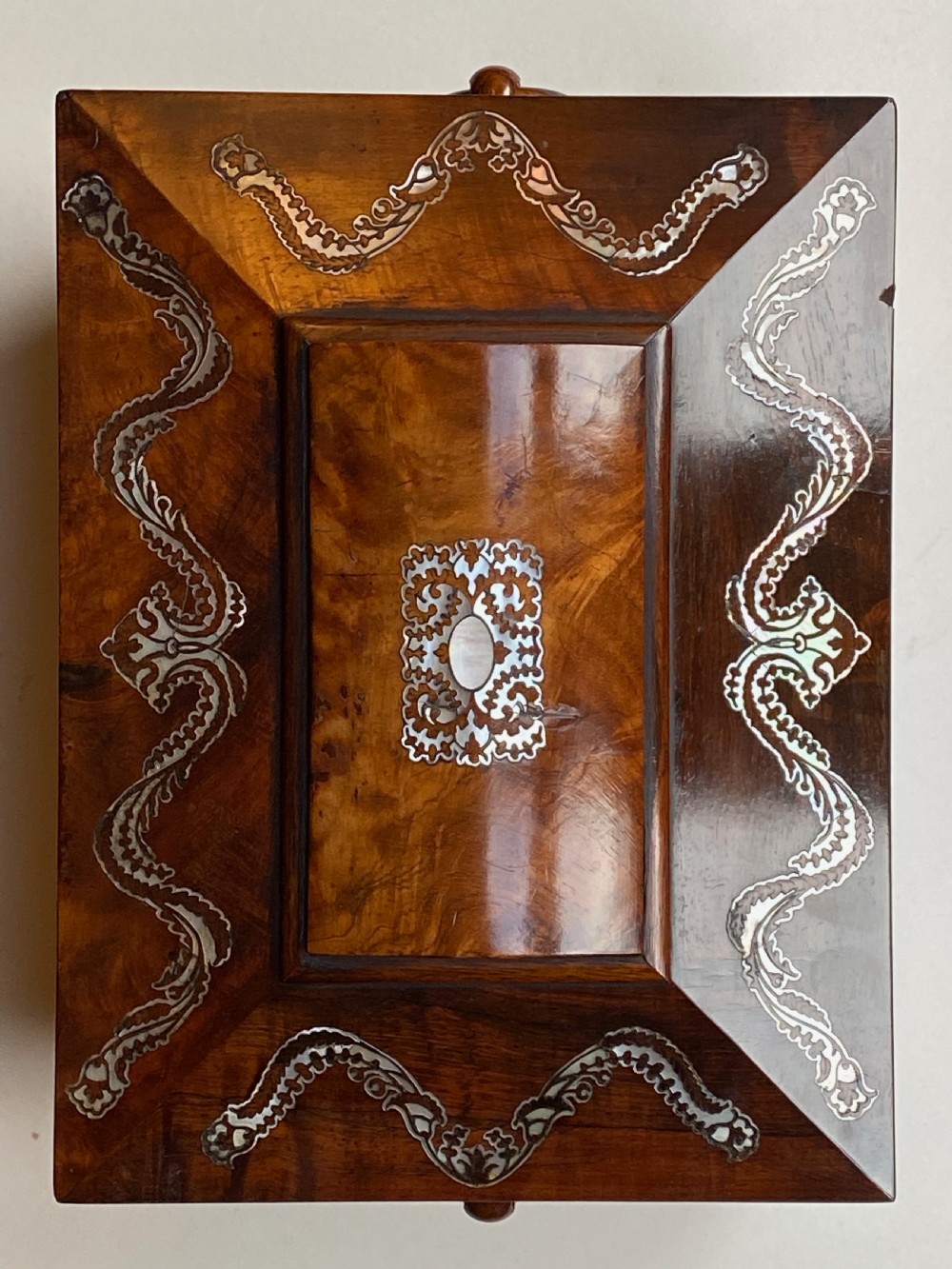 A Regency rosewood workbox with mother-of-pearl foliate inlays, side ring handles, and carved feet. View XI