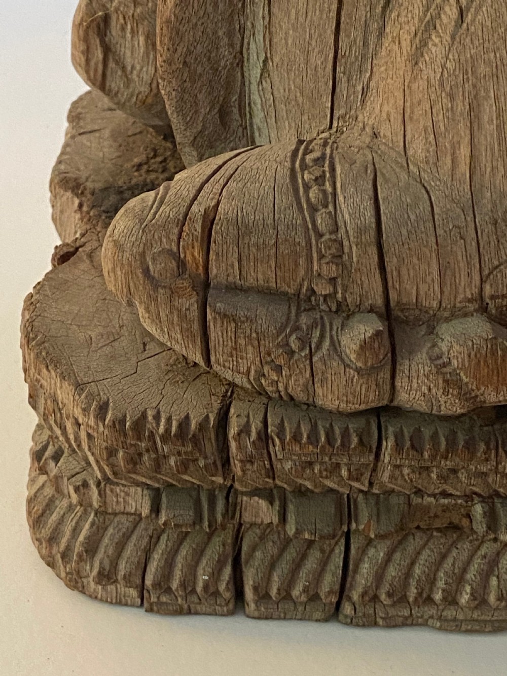 A carved wooden sculpture of a seated Nandi bull on a decorated plinth featuring intricate neck garlands and a saddle cover. View VIII