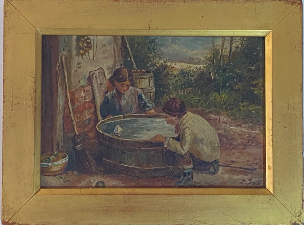 An 1884 Victorian oil painting on canvas by Albert-Ernest Brockbank depicting children playing with a toy boat in a water tub inside a broad gold gilt frame.