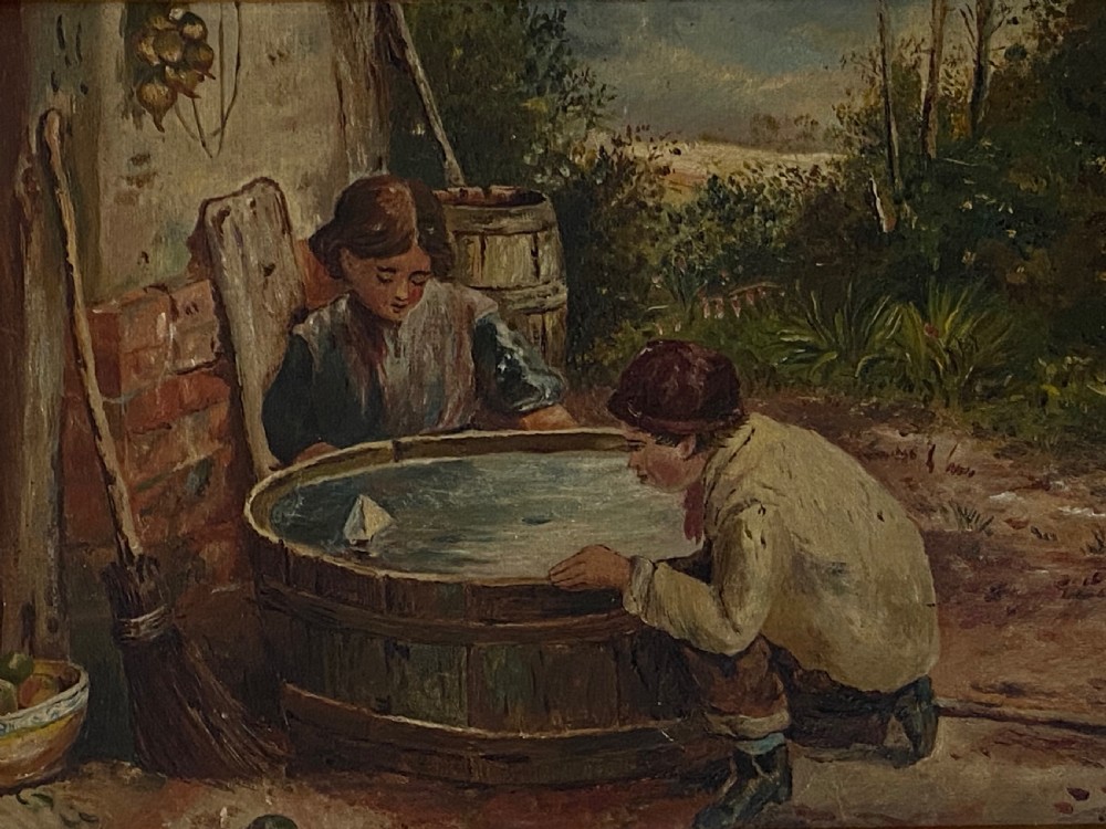 An 1884 Victorian oil painting on canvas by Albert-Ernest Brockbank depicting children playing with a toy boat in a water tub inside a broad gold gilt frame. View IV