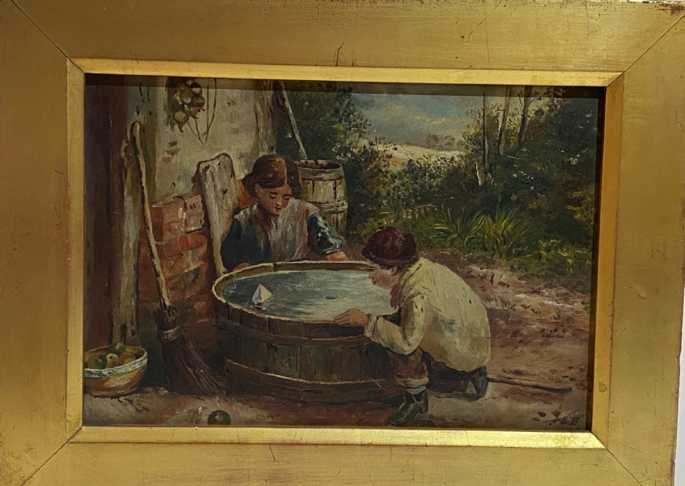 An 1884 Victorian oil painting on canvas by Albert-Ernest Brockbank depicting children playing with a toy boat in a water tub inside a broad gold gilt frame. View IX