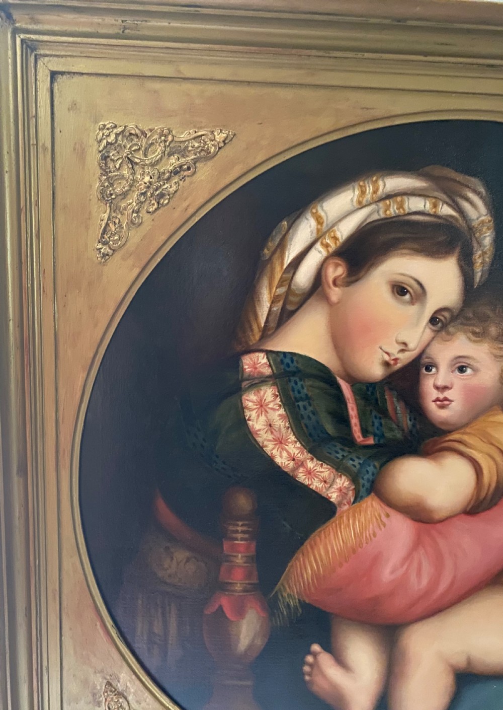 An antique square gilded frame housing a circular tondo oil painting depicting the Madonna embracing the Christ child alongside Saint John the Baptist. View IV