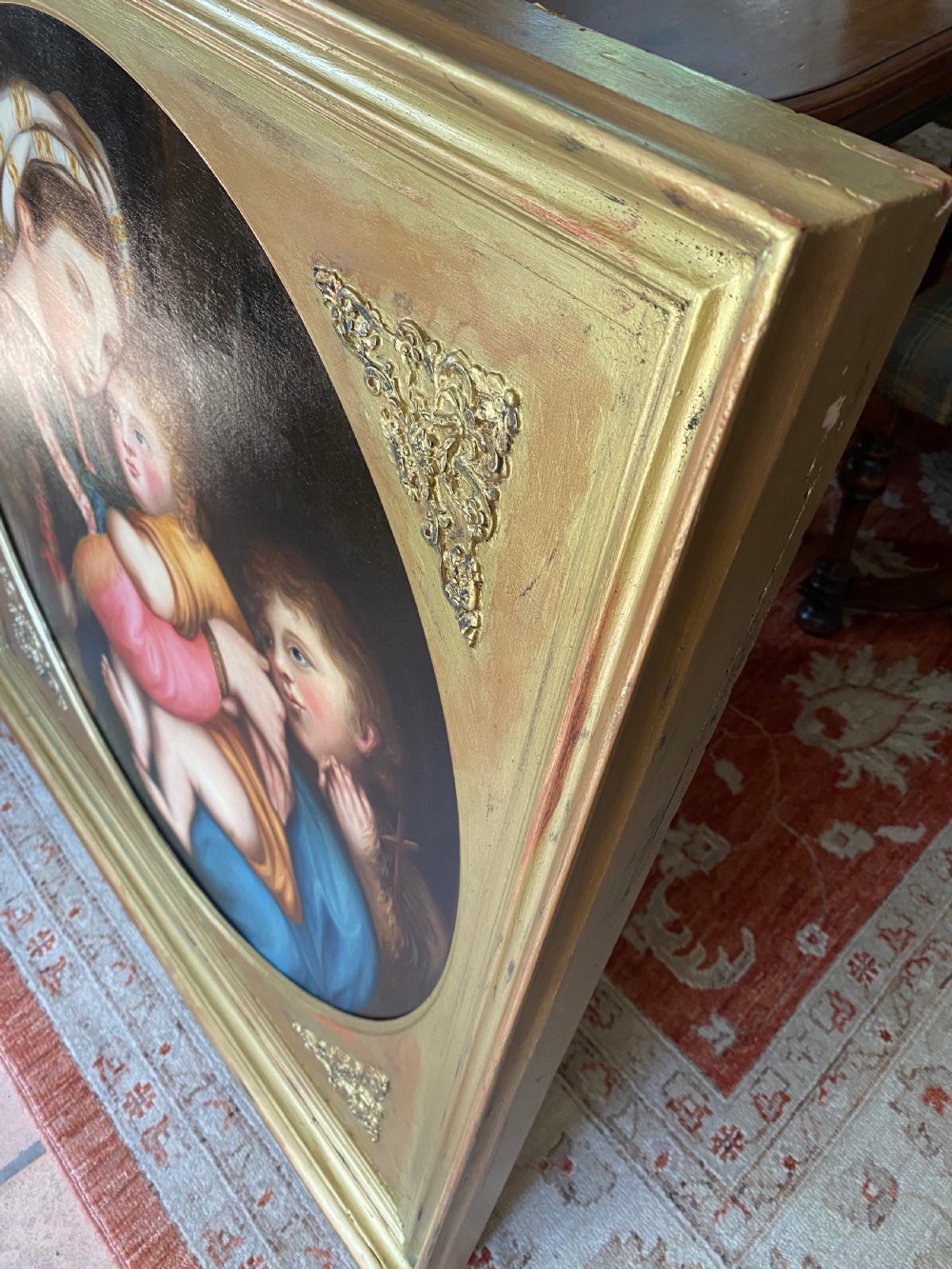An antique square gilded frame housing a circular tondo oil painting depicting the Madonna embracing the Christ child alongside Saint John the Baptist. View IX