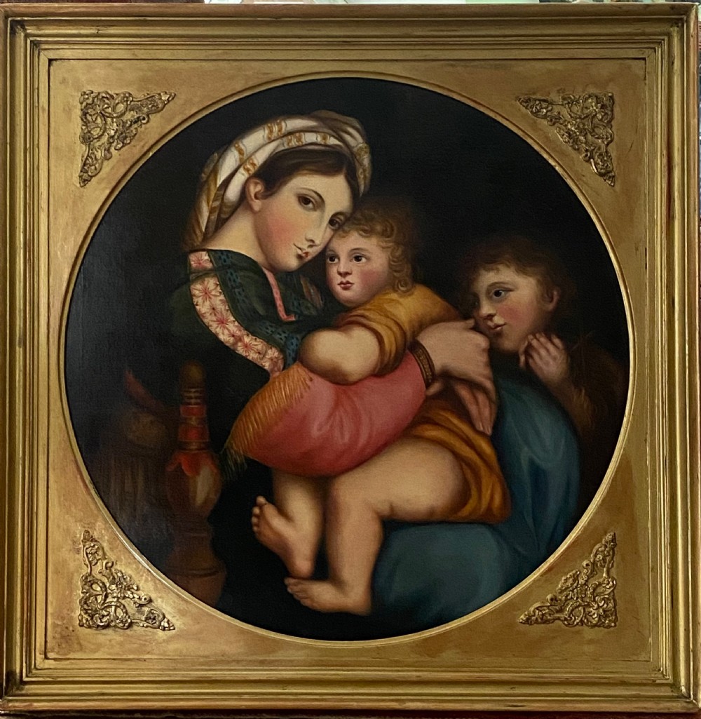 An antique square gilded frame housing a circular tondo oil painting depicting the Madonna embracing the Christ child alongside Saint John the Baptist. View X