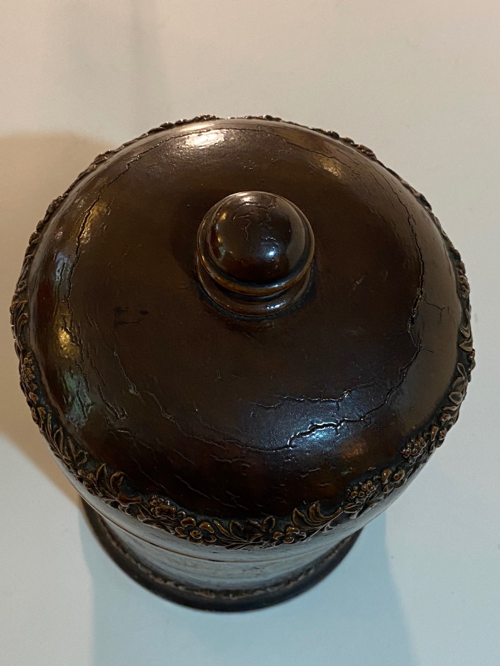 A mid-19th century brown glazed stoneware apothecary jar featuring floral relief borders and a label reading PULV AMYLI. View V