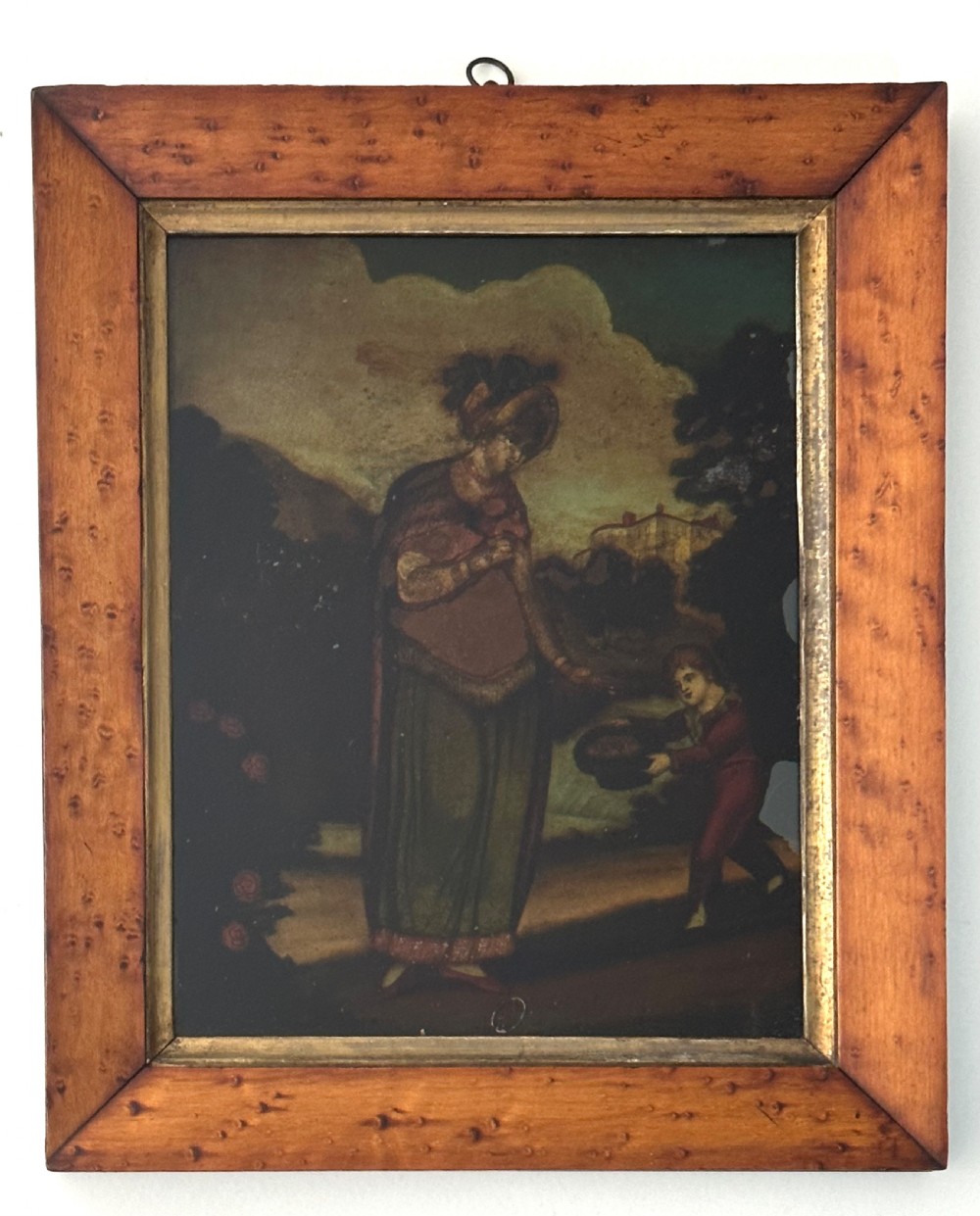 Set of four Regency reverse glass prints depicting figures representing the seasons, framed in birds-eye maple frames with gilt slips. View II