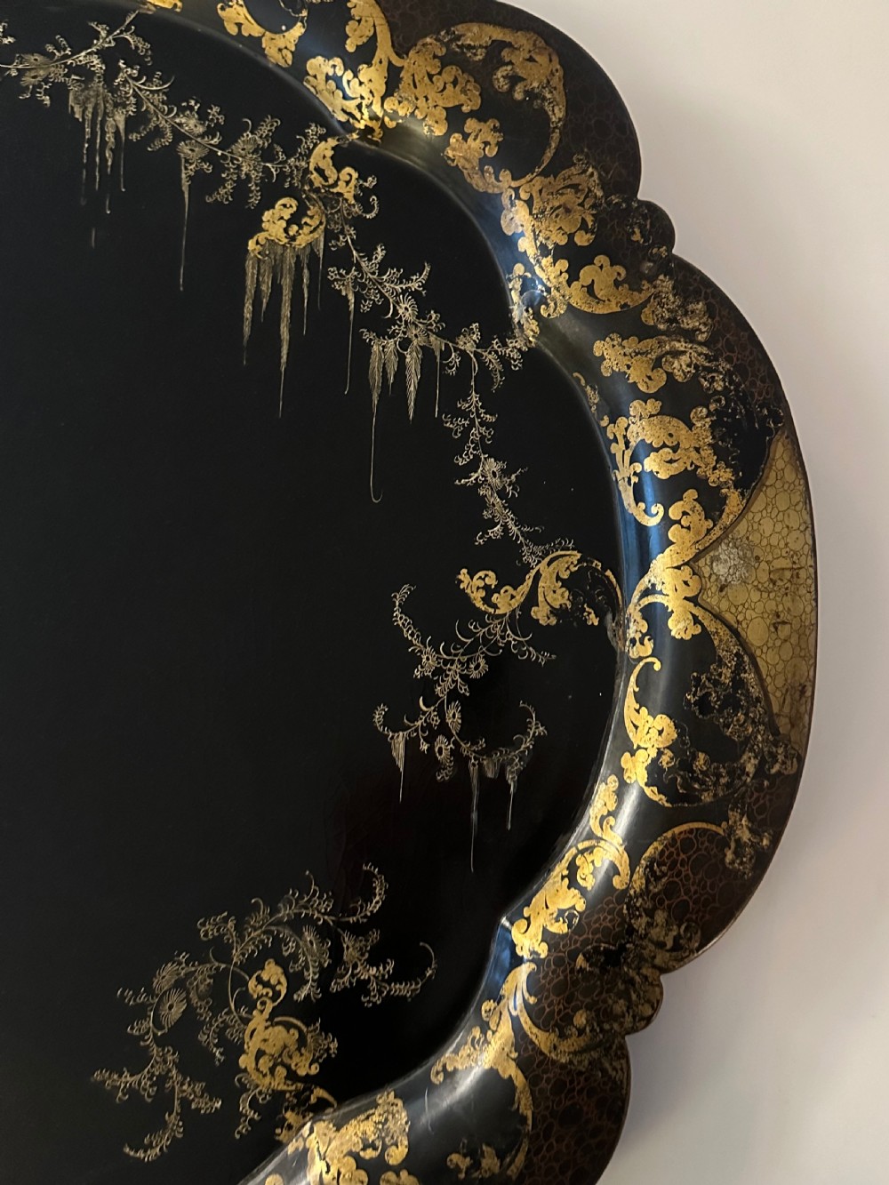 Large Victorian black papier-mache tray by Jennens and Bettridge featuring scalloped edges and detailed gilt scrollwork. View II
