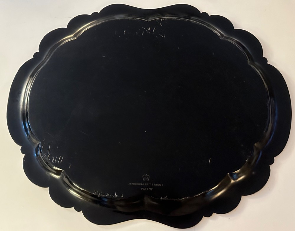 Large Victorian black papier-mache tray by Jennens and Bettridge featuring scalloped edges and detailed gilt scrollwork. View IV