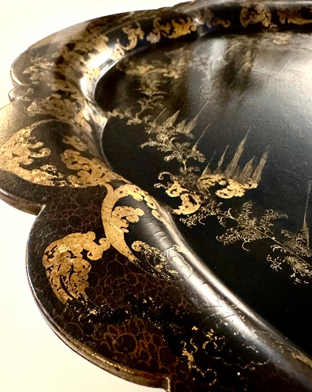 Large Victorian black papier-mache tray by Jennens and Bettridge featuring scalloped edges and detailed gilt scrollwork. View VII