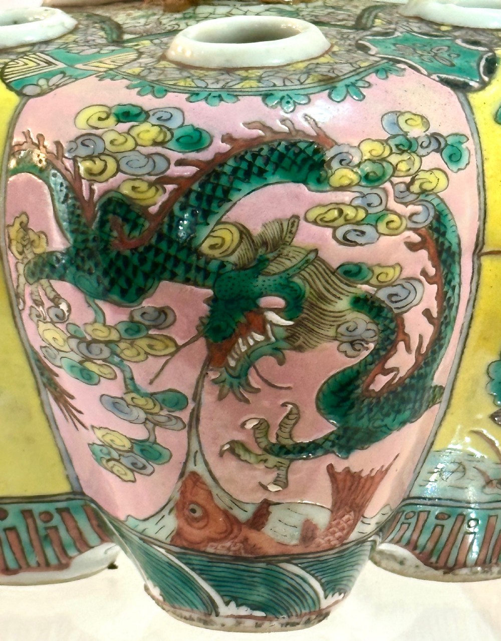 A Chinese polychrome porcelain tulip vase featuring multiple stem apertures, a central neck topped with a lotus bud, and hand-painted panels depicting birds and floral motifs. View III