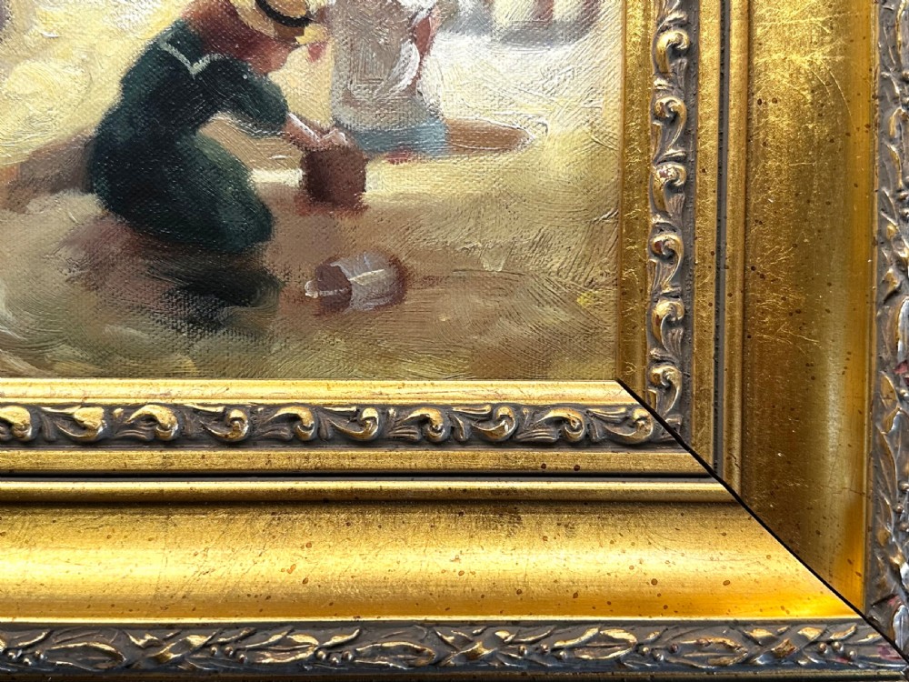An impressionist oil painting depicting crowds of figures gathered on a sandy beach beside a blue sea, presented in an ornate gold gilt frame. View IV