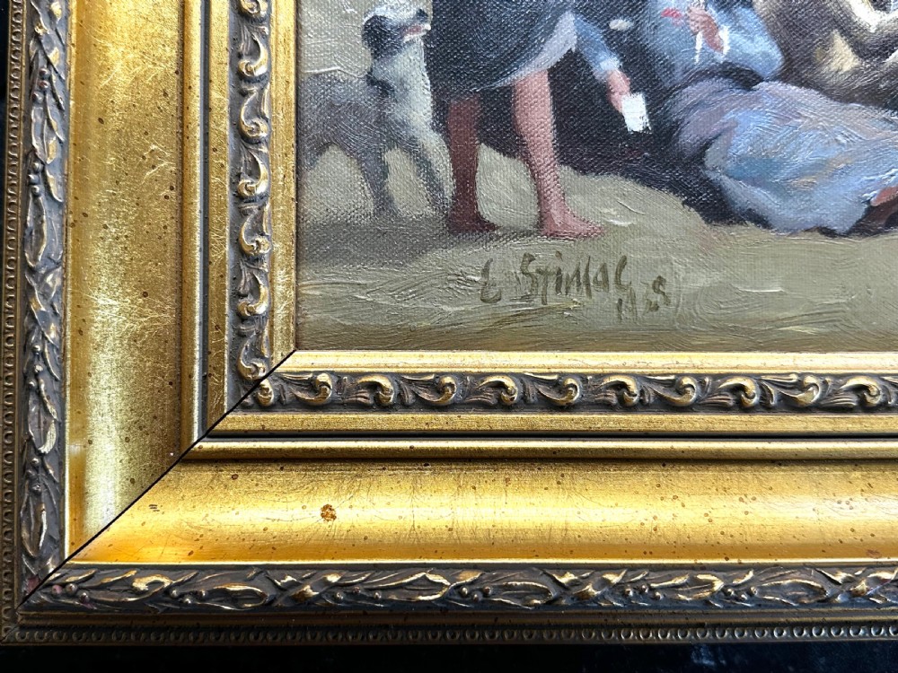 An impressionist oil painting depicting crowds of figures gathered on a sandy beach beside a blue sea, presented in an ornate gold gilt frame. View V