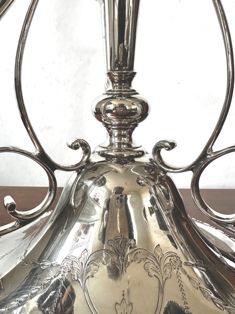 A silver-plated four-trumpet epergne table centrepiece featuring a central flared vase and three smaller removable side vases on a scrolled base. View V
