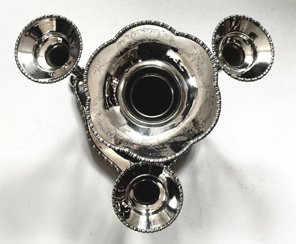 A silver-plated four-trumpet epergne table centrepiece featuring a central flared vase and three smaller removable side vases on a scrolled base. View VII