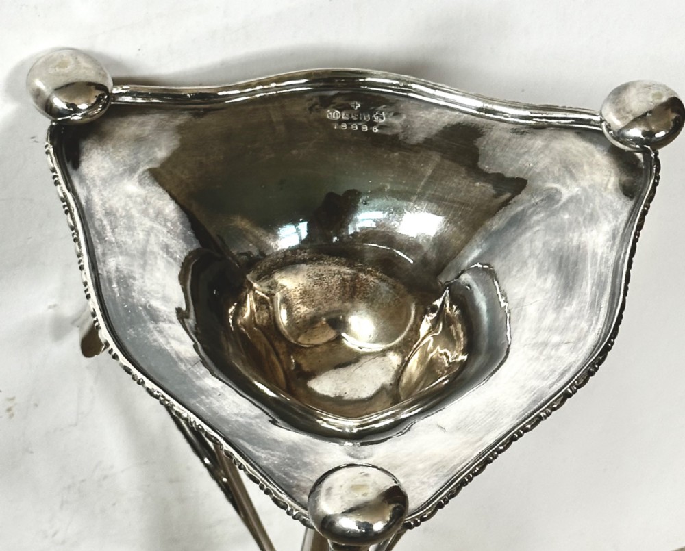 A silver-plated four-trumpet epergne table centrepiece featuring a central flared vase and three smaller removable side vases on a scrolled base. View X