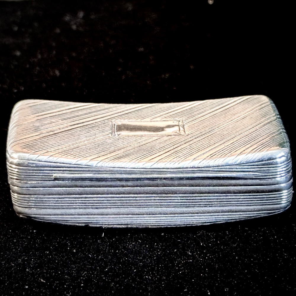 A rectangular antique silver snuff box featuring diagonal engine-turned reeding and a central unengraved rectangular cartouche. View III