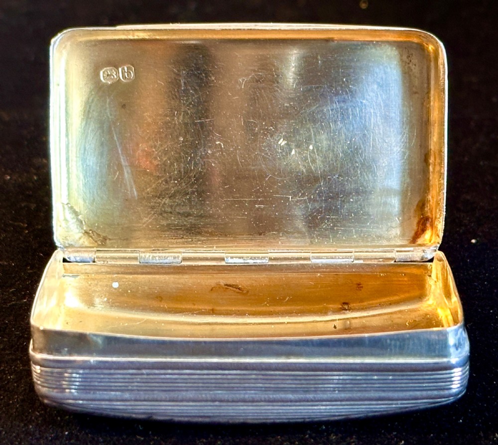 A rectangular antique silver snuff box featuring diagonal engine-turned reeding and a central unengraved rectangular cartouche. View IV