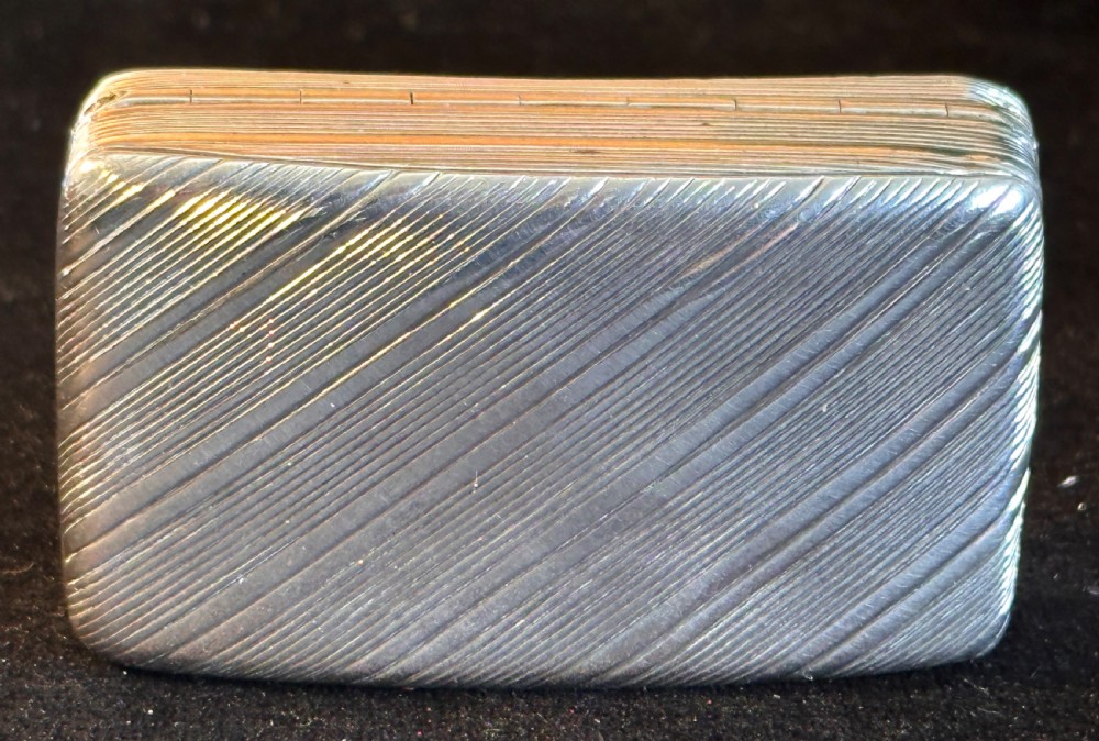 A rectangular antique silver snuff box featuring diagonal engine-turned reeding and a central unengraved rectangular cartouche. View VII
