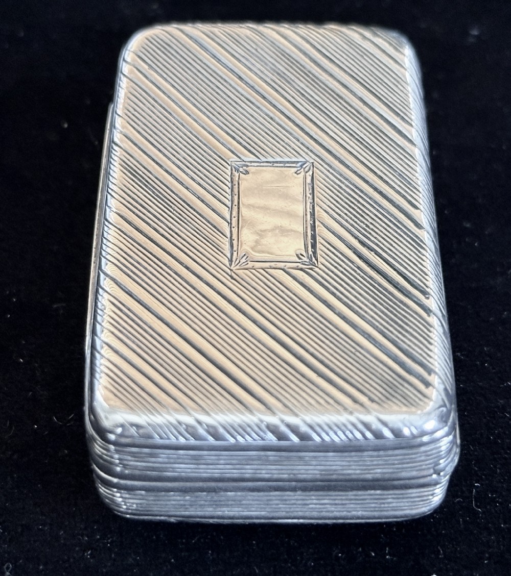 A rectangular antique silver snuff box featuring diagonal engine-turned reeding and a central unengraved rectangular cartouche. View XIII
