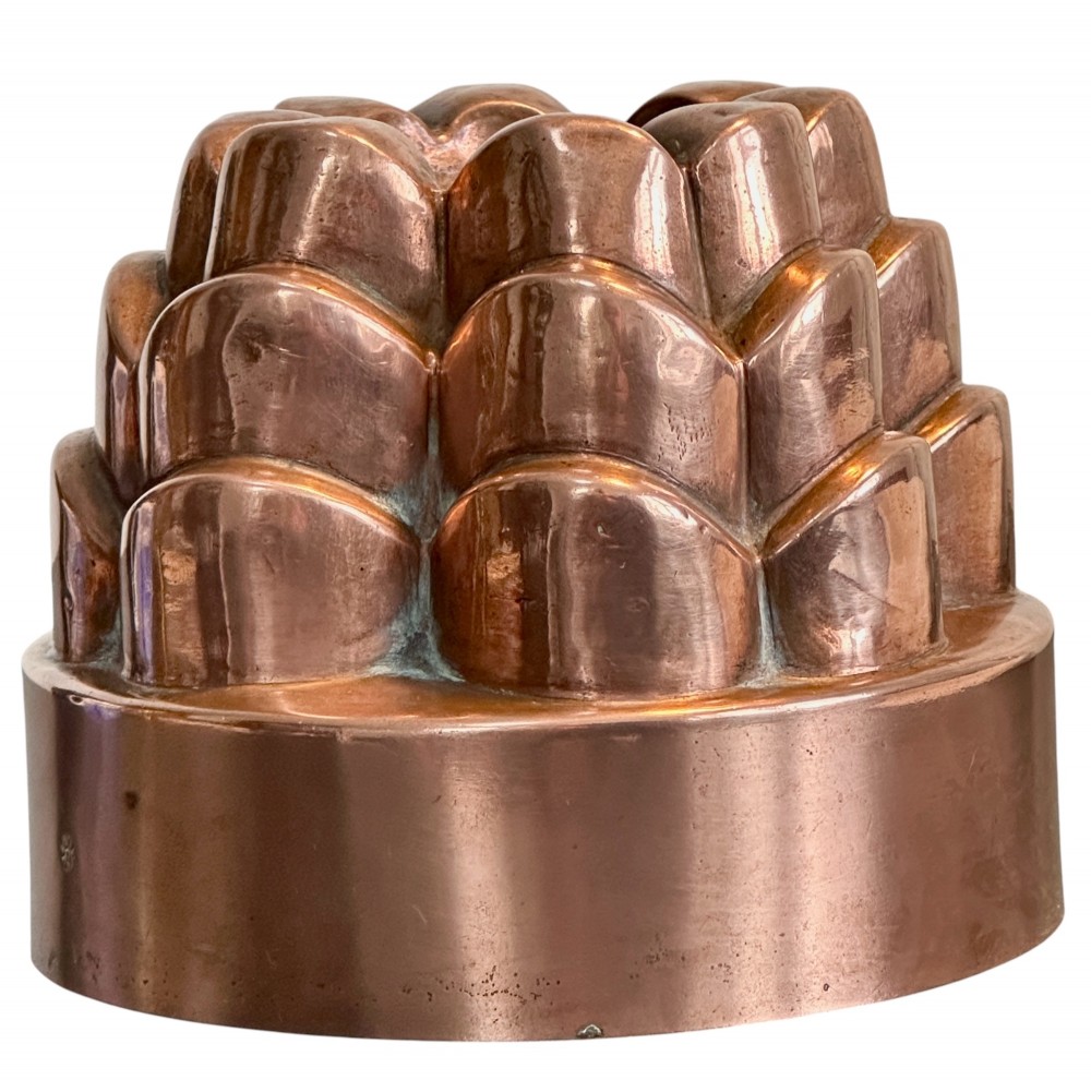 A Victorian copper jelly mould featuring a tiered castle design with fluted column detailing and a smooth circular base. View III