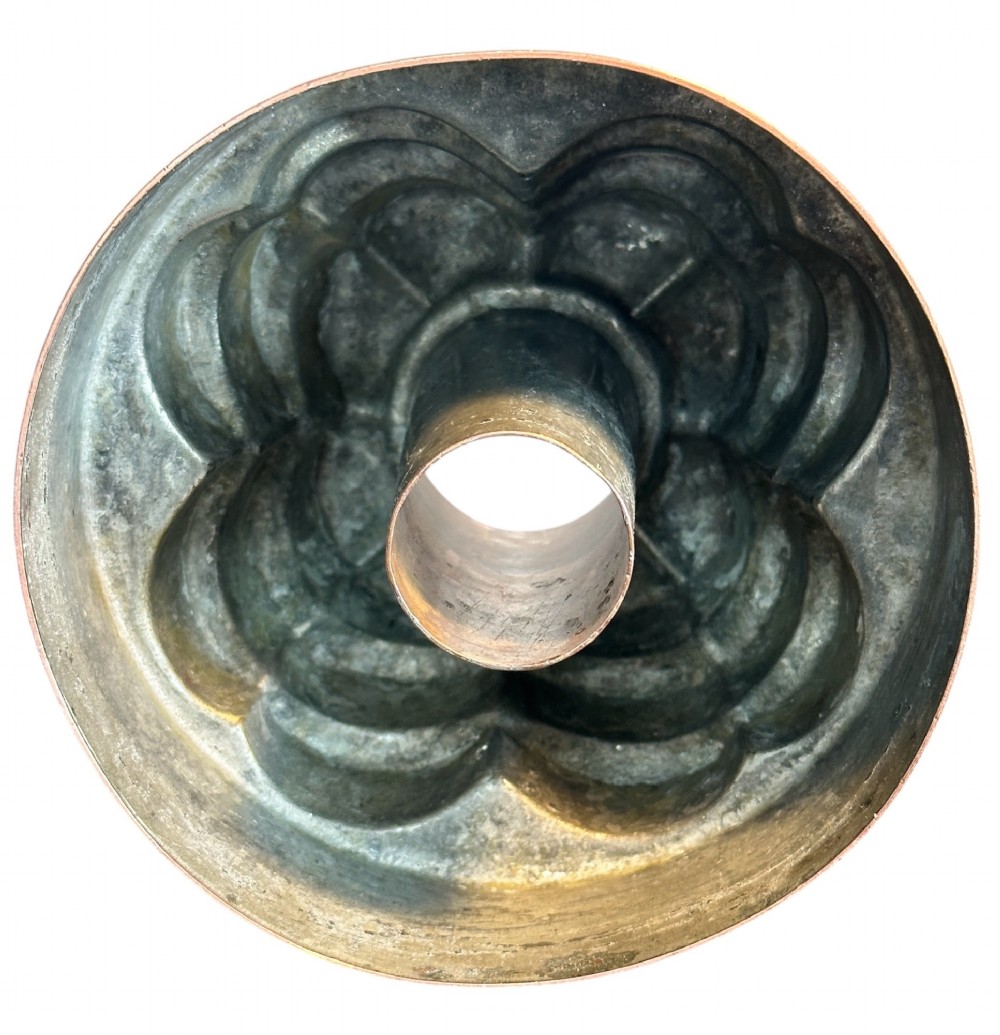 A Victorian copper jelly mould featuring a tiered castle design with fluted column detailing and a smooth circular base. View IV