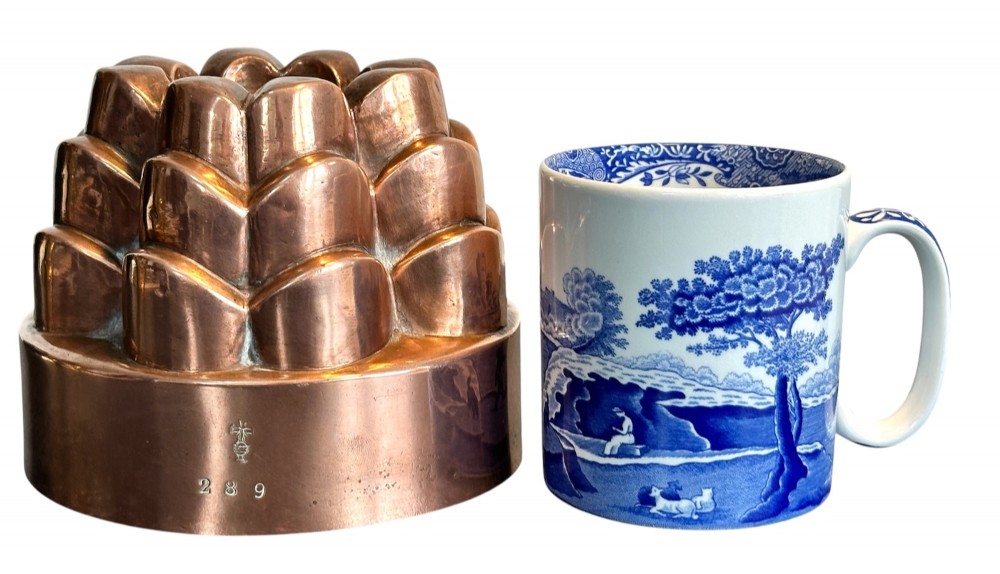 A Victorian copper jelly mould featuring a tiered castle design with fluted column detailing and a smooth circular base. View VI