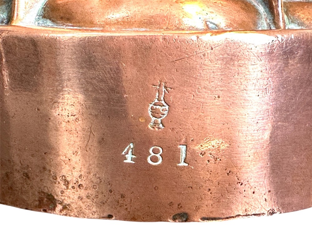 A Victorian stamped copper jelly mould featuring a multi-columned tiered architectural design with a central aperture. View II