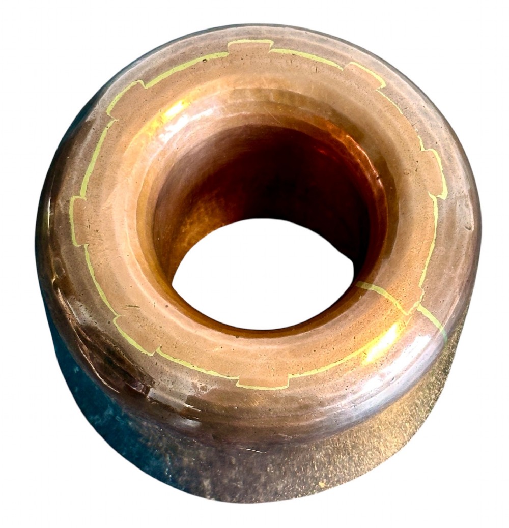 A cylindrical polished copper jelly mould with a smooth exterior and central ring well. View II