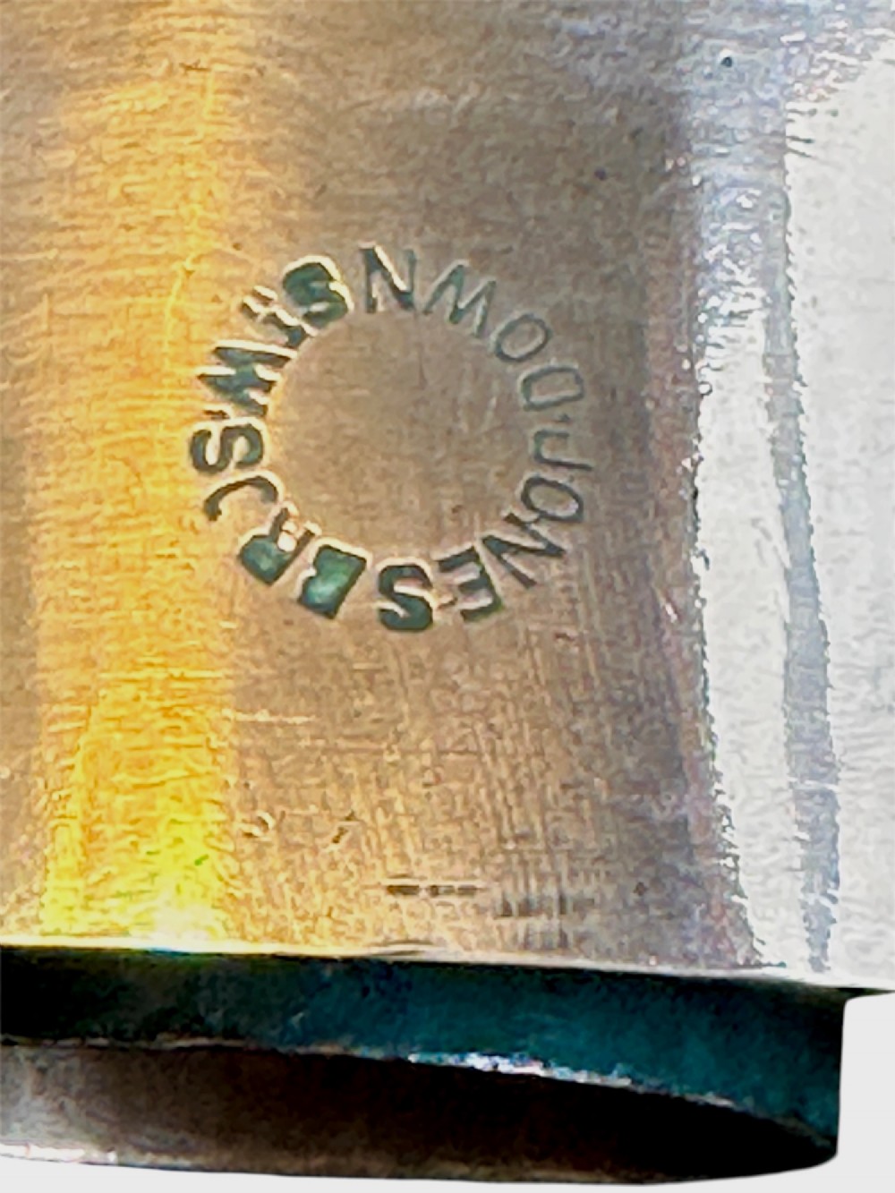 A cylindrical polished copper jelly mould with a smooth exterior and central ring well. View IV