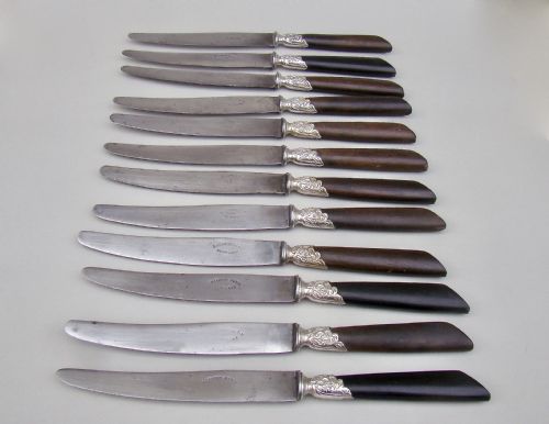 Set of Twelve 19th C. French Table Knives with Ebony Handles, Silver Plated Ferrules and Steel Blades, Circa 1890

