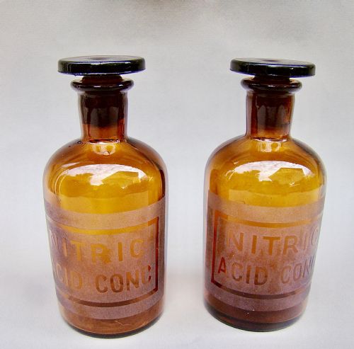 fig 1. UNUSUAL PAIR OF EARLY 20TH CENTURY AMBER GLASS CHEMISTRY BOTTLES, CIRCA 1920