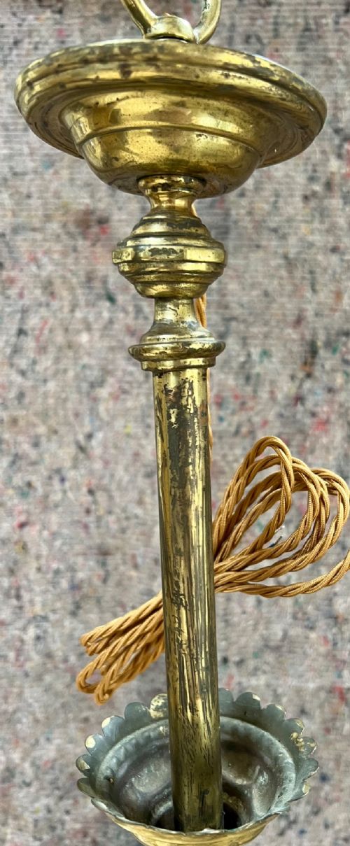 An antique brass hanging pendant lantern featuring a contoured brass frame suspending a moulded pink and amber glass shade. View IV