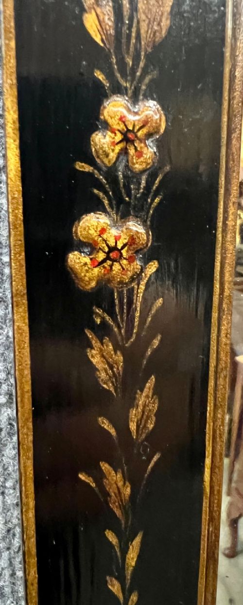 A tall, narrow black lacquered hall mirror decorated with gilded Chinoiserie pagodas and figures, featuring an arched top and front cabriole legs. View IV