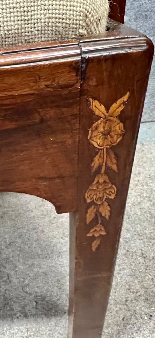 An antique mahogany armchair featuring floral marquetry wood inlays throughout the frame and splat, fitted with a floral needlepoint upholstered seat. View IX