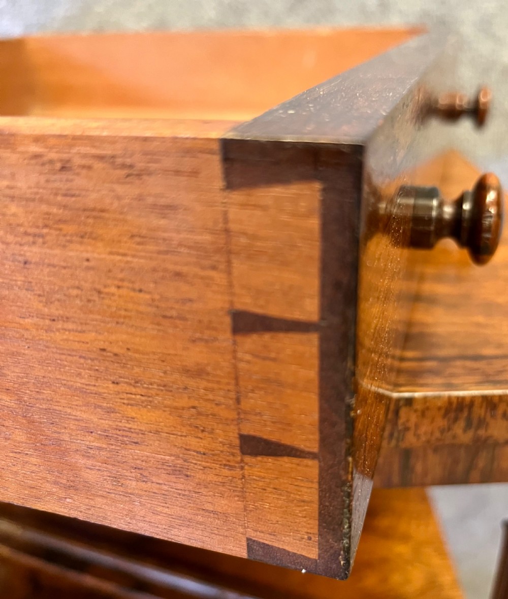 A four-tier rosewood whatnot featuring an adjustable angled top reading slope, fluted supports, a bottom drawer, and brass castors. View VII
