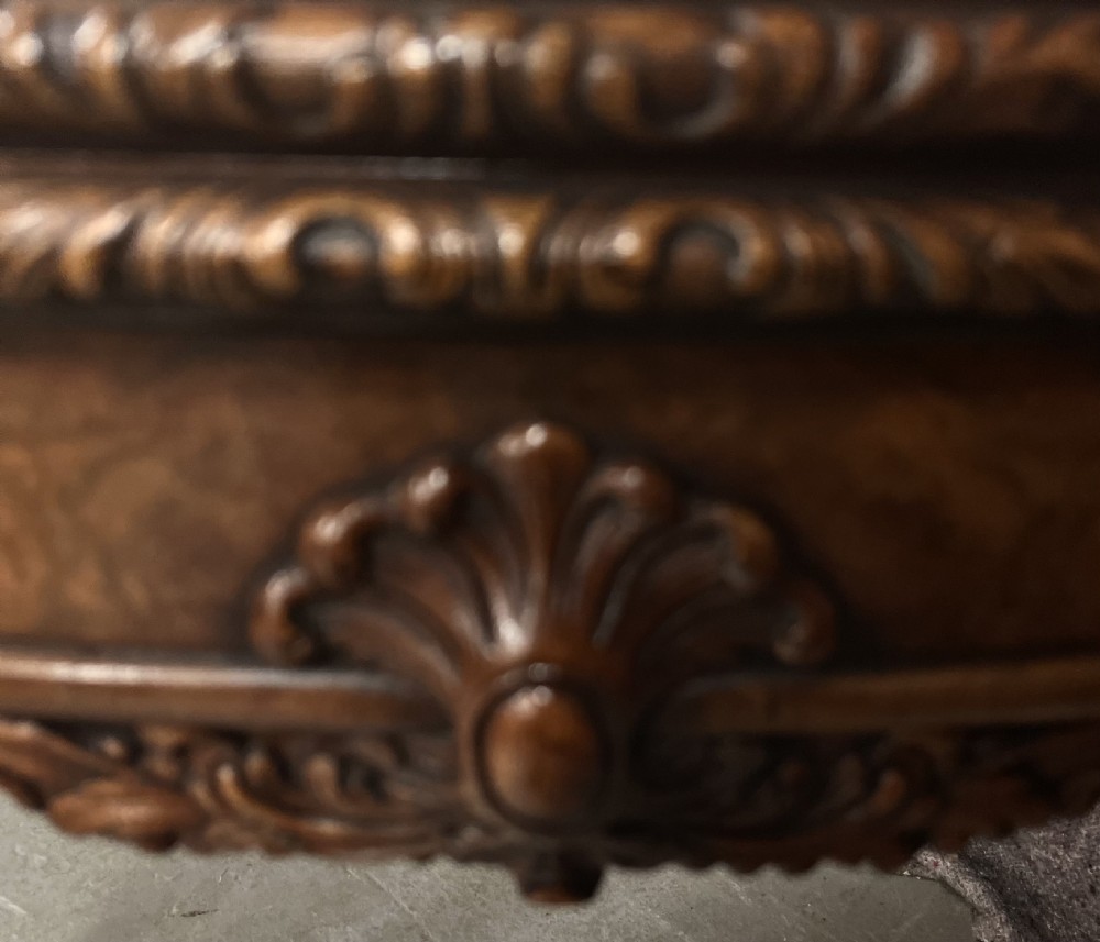 A burr walnut card table featuring a serpentine top with crossbanded borders, an ornate shell-carved apron, and cabriole legs ending in ball and claw feet. View IV