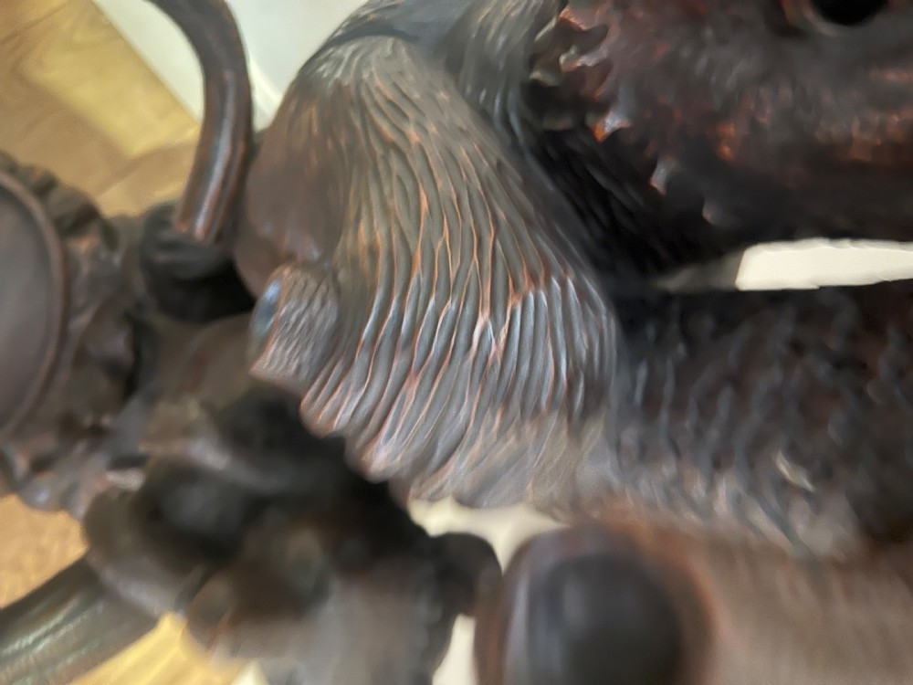 A tall dark wood hand-carved Black Forest hall stand featuring climbing bear figures, branch-form coat pegs, and an integrated umbrella ring with a drip pan base. View VII