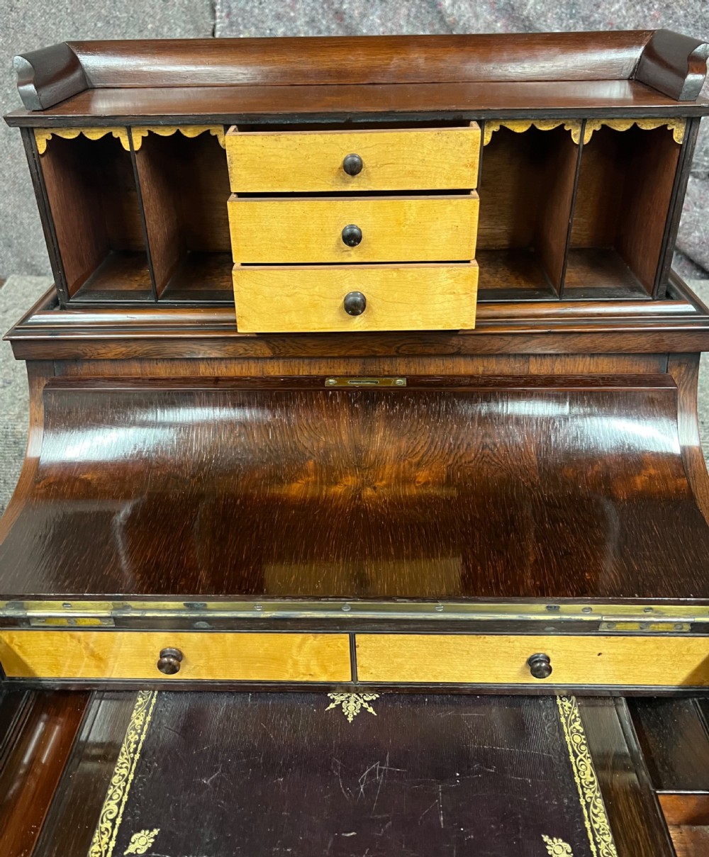 A Victorian rosewood Davenport writing desk featuring a pop-up stationery compartment, sloped leather writing surface, and carved cabriole legs. View VIII