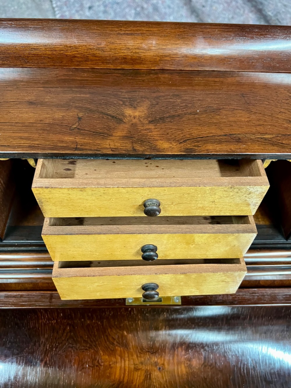 A Victorian rosewood Davenport writing desk featuring a pop-up stationery compartment, sloped leather writing surface, and carved cabriole legs. View IX