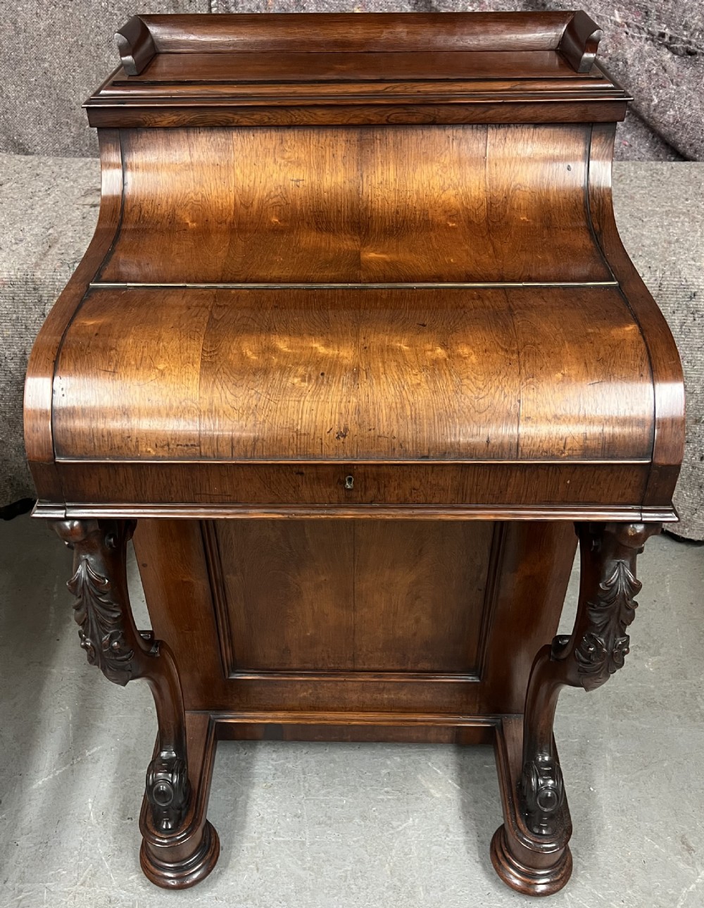 A Victorian rosewood Davenport writing desk featuring a pop-up stationery compartment, sloped leather writing surface, and carved cabriole legs. View XII