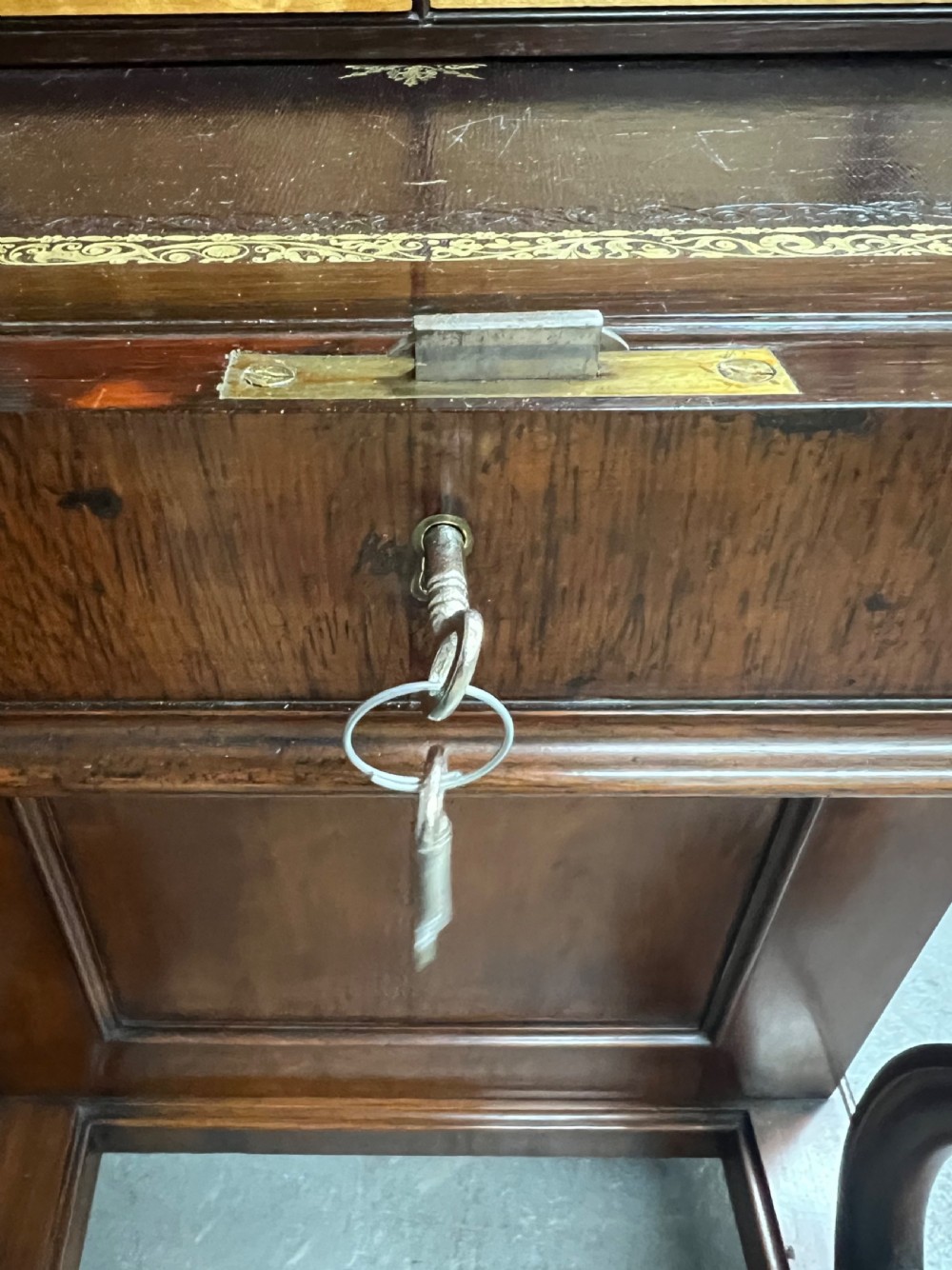 A Victorian rosewood Davenport writing desk featuring a pop-up stationery compartment, sloped leather writing surface, and carved cabriole legs. View XIII