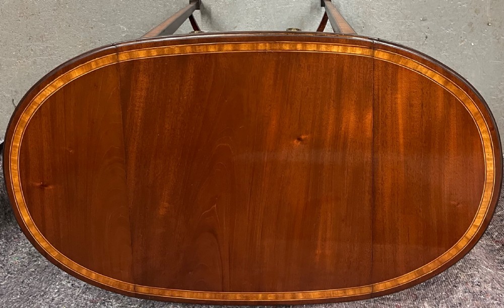 An Edwardian mahogany Pembroke side table featuring satinwood crossbanding, drop leaves, a single drawer with twin brass handles, square tapered legs, and a curved lower X-stretcher. View III