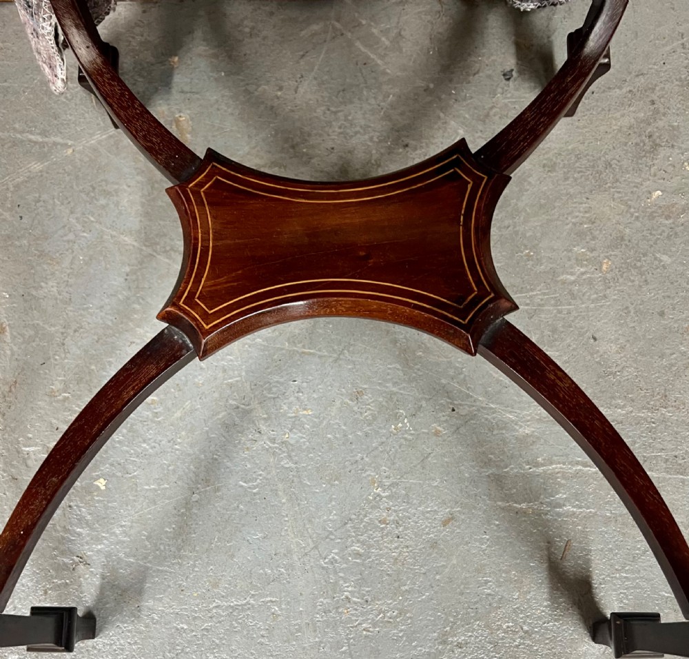 An Edwardian mahogany Pembroke side table featuring satinwood crossbanding, drop leaves, a single drawer with twin brass handles, square tapered legs, and a curved lower X-stretcher. View V
