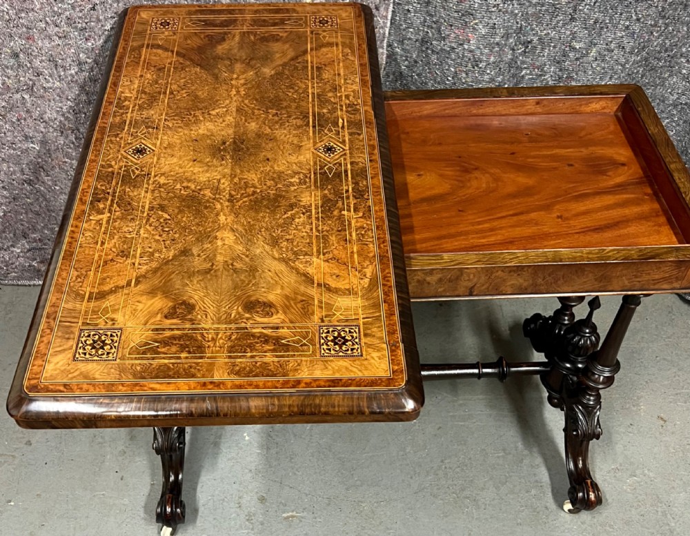A Victorian burr walnut card table featuring geometric Tunbridge Ware inlay, turned twin-column supports, and a stretcher base on castors. View V