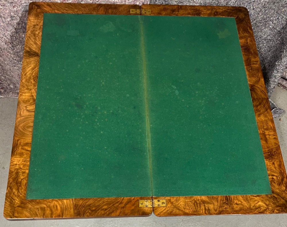 A Victorian burr walnut card table featuring geometric Tunbridge Ware inlay, turned twin-column supports, and a stretcher base on castors. View VI