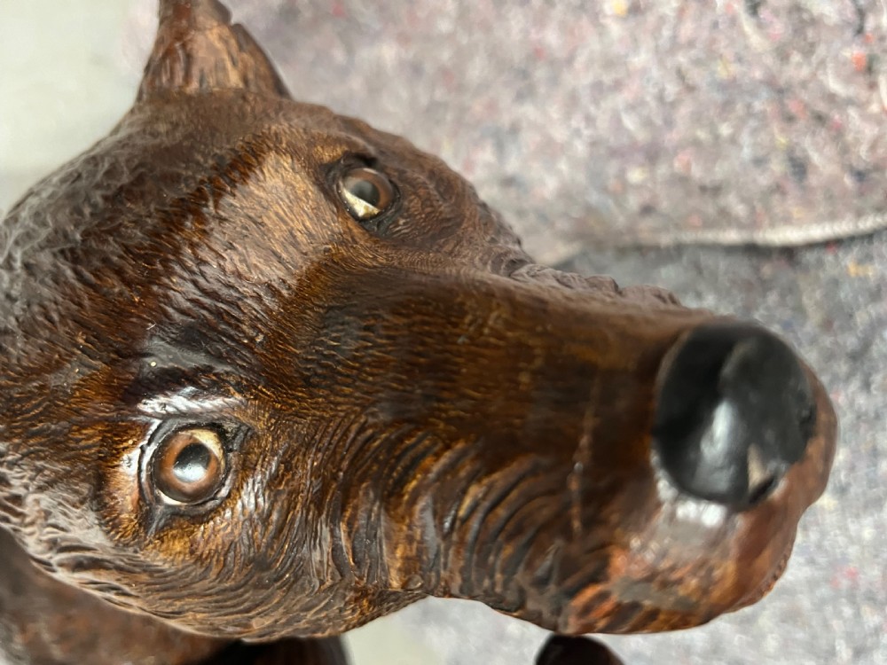 A dark wood hand-carved Black Forest hall stand featuring a fox at the base looking up towards an owl perched atop branch-form hooks. View IV