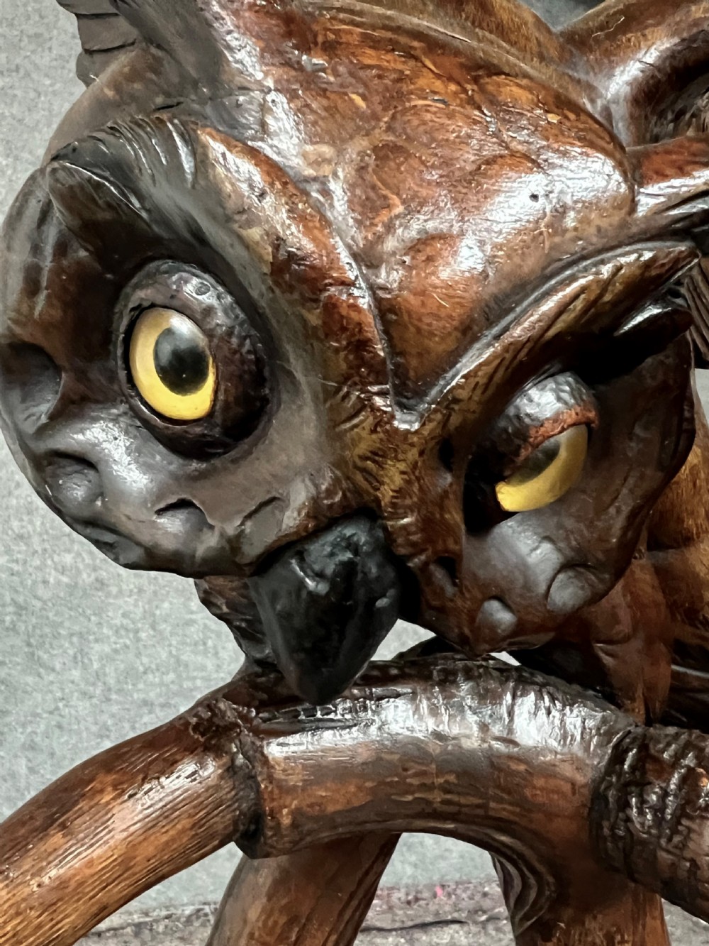 A dark wood hand-carved Black Forest hall stand featuring a fox at the base looking up towards an owl perched atop branch-form hooks. View VI
