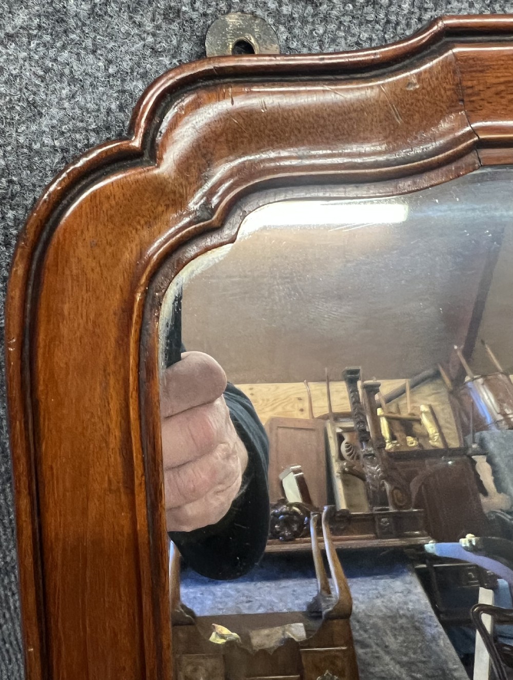 A tall antique mirror featuring a moulded mahogany frame with a curved top arch. View IV